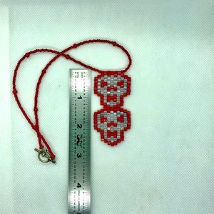 Hand beaded double skull necklace